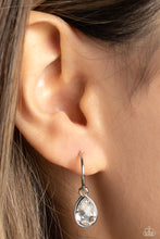 Load image into Gallery viewer, A small, skinny, shiny silver hoop curves around the ear in a timeless fashion. A shiny silver ball is affixed to the end of the hoop, reminiscent of a barbell fitting. A white, teardrop gem, encased in a shiny silver frame slides along the curvature of the hoop, adding a surprising hint of shimmery movement. Earring attaches to a standard post fitting. Hoop measures approximately 1/2&quot; in diameter.  Sold as one pair of hoop earrings.
