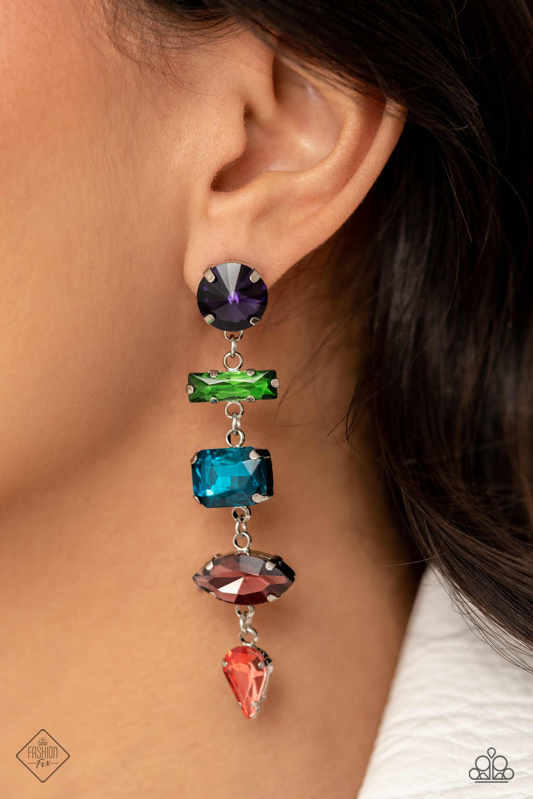Five various-cut multicolored rhinestones, set in classic shiny silver pronged settings, stack one over the other creating a colorfully industrial lure. Earring attaches to a standard post fitting.  Sold as one pair of post earrings.