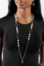 Load image into Gallery viewer, A classy collection of oversized white pearls, silver discs, and faceted chiseled clear beads trickle along an elongated shimmery silver chain for a refined look. A lobster clasp hangs from the bottom of the design to allow a name badge or other item to be attached. Features an adjustable clasp closure.  Sold as one individual lanyard. Includes one pair of matching earrings.
