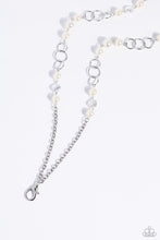 Load image into Gallery viewer, A classy collection of oversized white pearls, silver discs, and faceted chiseled clear beads trickle along an elongated shimmery silver chain for a refined look. A lobster clasp hangs from the bottom of the design to allow a name badge or other item to be attached. Features an adjustable clasp closure.  Sold as one individual lanyard. Includes one pair of matching earrings.

