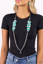 Load image into Gallery viewer, Flared between two oversized silver beads, a collection of turquoise and white shell-like beads give way to sections of silver chains that connect across the chest for a colorful summery look. A lobster clasp hangs from the bottom of the elongated design to allow a name badge or other item to be attached. Features an adjustable clasp closure.  Sold as one individual lanyard. Includes one pair of matching earrings.
