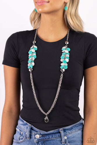 Flared between two oversized silver beads, a collection of turquoise and white shell-like beads give way to sections of silver chains that connect across the chest for a colorful summery look. A lobster clasp hangs from the bottom of the elongated design to allow a name badge or other item to be attached. Features an adjustable clasp closure.  Sold as one individual lanyard. Includes one pair of matching earrings.