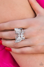 Load image into Gallery viewer, Sparkling with round, teardrop, and emerald cut white rhinestones, a silver butterfly fearlessly flutters atop the finger for a statement-making finish. Features a stretchy band for a flexible fit.  Sold as one individual ring.

