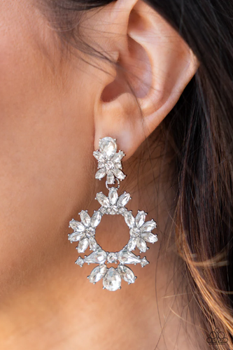 Life of the Party! Ablaze with a mismatched assortment of brilliant white rhinestones, a stunning wreath swings from the bottom of a dainty white rhinestone fitting for a jaw-dropping dazzle. Earring attaches to a standard post fitting.  Sold as one pair of post earrings.